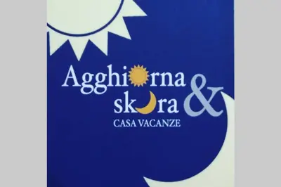 a bottle of wine and a plate of lemons and a wine glass at Agghiorna&skura house in Palermo