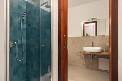 a bathroom with a glass shower and a sink at Piazza Marina Open Space in Palermo
