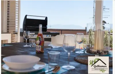 a table with glasses and a bottle of wine at Gelkamar Apartment in Santa Flavia