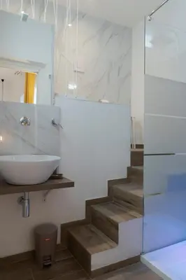 a white room with a bed and a table at Carrettieri54 - apartment historic center Palermo in Palermo