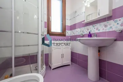 a purple and white bathroom with a sink and a toilet at Villa Pietro in Lascari