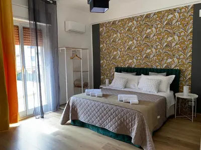 a bedroom with a large bed with a wall at Civico 20 in Palermo