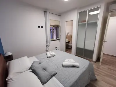 a bedroom with a bed with two towels on it at La Casetta Di Rosina in Caccamo
