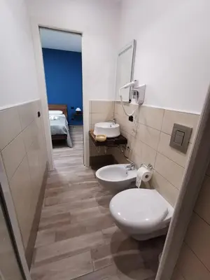 a bathroom with a toilet and a sink and a mirror at La Casetta Di Rosina in Caccamo