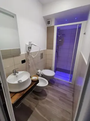 a bathroom with a sink and a toilet and a shower at La Casetta Di Rosina in Caccamo