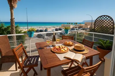 a table with a plate of food on a balcony with the beach at Villa Mirage in Alcamo