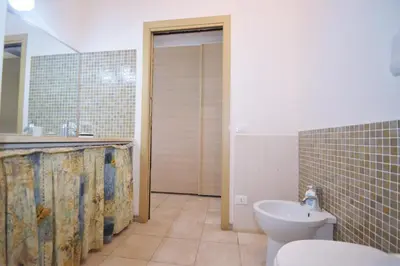 a bathroom with a toilet and a sink at Villa Mirage in Alcamo