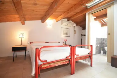 a bedroom with a bed and a table with a lamp at Villa Mirage in Alcamo