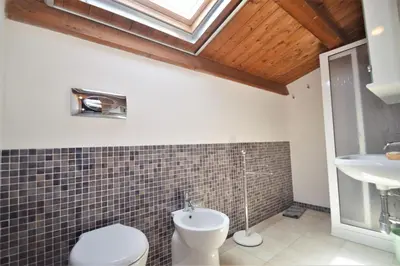 a bathroom with a toilet and a sink at Villa Mirage in Alcamo