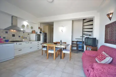 a living room with a pink couch and a table at Villa Mirage in Alcamo