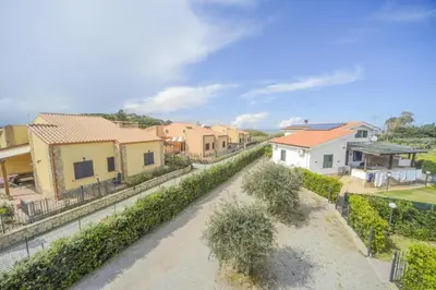 an empty street in a village with houses at Case Vacanze Mare Nostrum - Villas in front of the Beach with Pool in Campofelice di Roccella