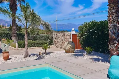 a swimming pool in a yard with palm trees at Villa Ciuridda in Alcamo