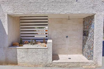 a window in a stone wall with a shelf with cactus at Villa Ciuridda in Alcamo