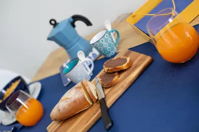 a cutting board with a loaf of bread and a knife at Coral Holiday San Vito Lo Capo in San Vito lo Capo
