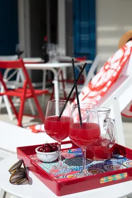 two glasses of red wine on a tray on a table at Coral Holiday San Vito Lo Capo in San Vito lo Capo