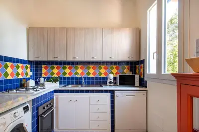 a kitchen with a stove top oven next to a window at La Casa nell'Oliveto a San Martino in Monreale
