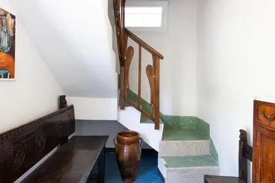 a room with stairs and a vase on the floor at La Casa nell'Oliveto a San Martino in Monreale