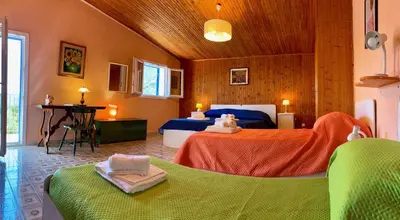 a bedroom with two beds and a desk in it at La Casa nell'Oliveto a San Martino in Monreale