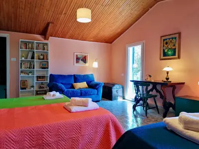 a living room with a blue couch and a table at La Casa nell'Oliveto a San Martino in Monreale