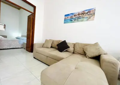 a living room with a brown couch in a room at Casa Kennedy in Capaci