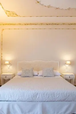 a white bed with two pillows in a bedroom at Appartamenti Porto Antico La Cala in Palermo