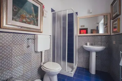 a bathroom with a toilet and a sink at Cinematocasa Suite in Palermo