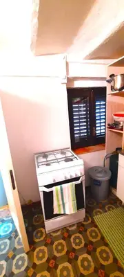 a toy kitchen with a stove and a floor at Cinematocasa Suite in Palermo