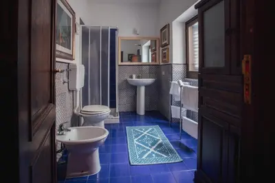 a bathroom with two toilets and a sink at Cinematocasa Suite in Palermo