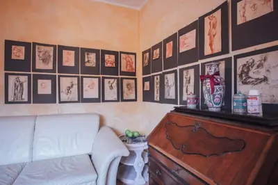 a living room with a couch and pictures on the wall at Cinematocasa Suite in Palermo