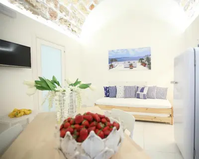 a room with a table with a bowl of fruit on it at BLU MARE suite privata & apartment in Terrasini