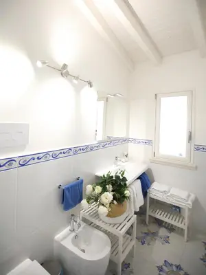a white bathroom with a sink and a toilet at BLU MARE suite privata & apartment in Terrasini
