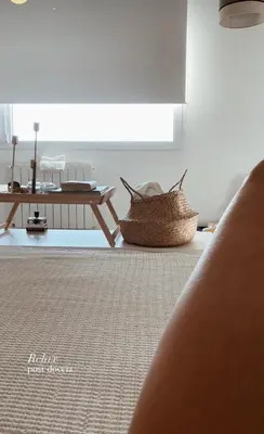 a living room with a table and a basket on the floor at Cocciu d’amuri in Terrasini
