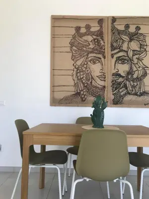 a dining room with a wooden table and chairs at Cocciu d’amuri in Terrasini