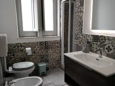 a bathroom with a toilet and a sink at Olivuzza Serena in Palermo