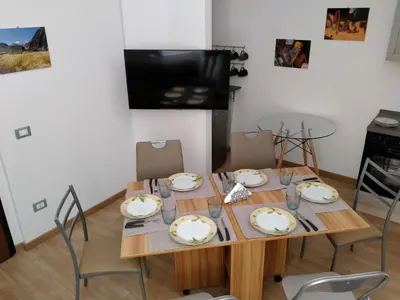 a dining room table with four chairs and a table and chairsktop at Olivuzza Serena in Palermo