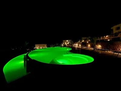 a green golf course lit up at night at Villa Edori - Giardino degli Allori in Castellammare del Golfo
