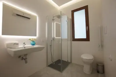 a bathroom with a toilet and a sink and a shower at Stabile HolidayHome in Castellammare del Golfo