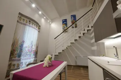 a room with a purple table with a sink and stairs at Stabile HolidayHome in Castellammare del Golfo