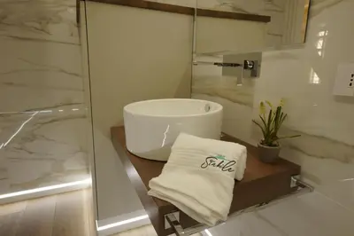 a bathroom with a sink and a glass shower at Stabile HolidayHome in Castellammare del Golfo