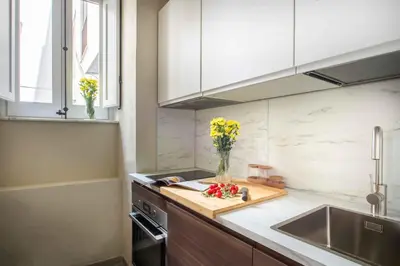 a kitchen with a vase of flowers on a counter at Casa dell'Architetto alla Cattedrale by Wonderful Italy in Palermo