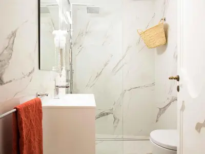 a white bathroom with a sink and a shower at Casa dell'Architetto alla Cattedrale by Wonderful Italy in Palermo