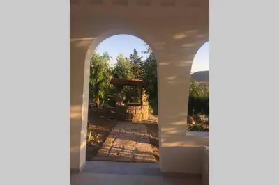 an archway with a view of a stone pathway at Gibilrossa BeeHill in Misilmeri