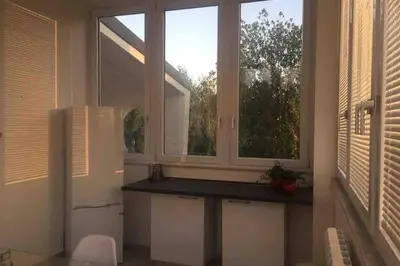 a kitchen with a window and a white refrigerator at Gibilrossa BeeHill in Misilmeri
