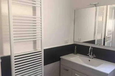 a bathroom with a sink and a mirror at Gibilrossa BeeHill in Misilmeri