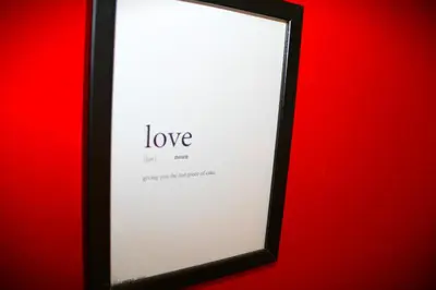 a black framed mirror with the word love on it at Casa gianflò in Palermo