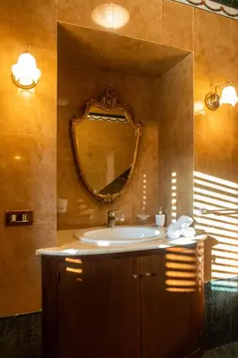 a bathroom with a sink and a mirror at Camera Vento Porto Antico La Cala in Palermo