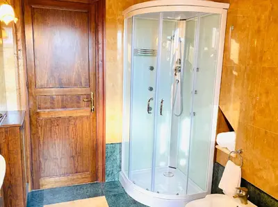 a bathroom with a shower and a toilet at Camera Vento Porto Antico La Cala in Palermo