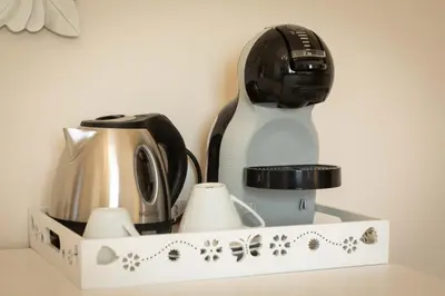a coffeemaker and a coffee maker in a box at Camera Vento Porto Antico La Cala in Palermo