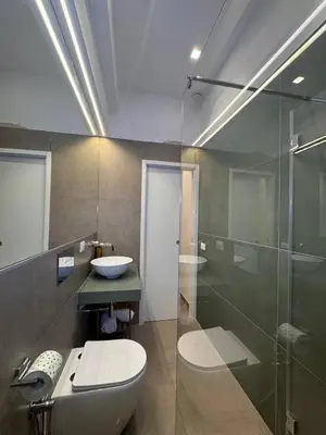 a bathroom with a toilet and a sink and a shower at Palermo Inn in Palermo