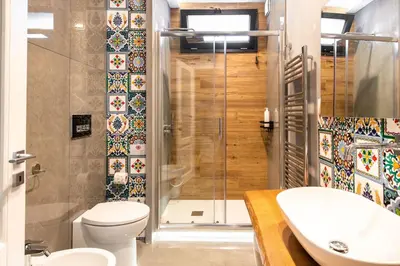 a bathroom with a shower and a toilet and a sink at Villena Plaza by Wonderful Italy in Palermo